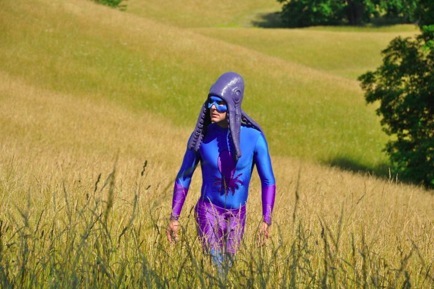 Squid Man walking in a field